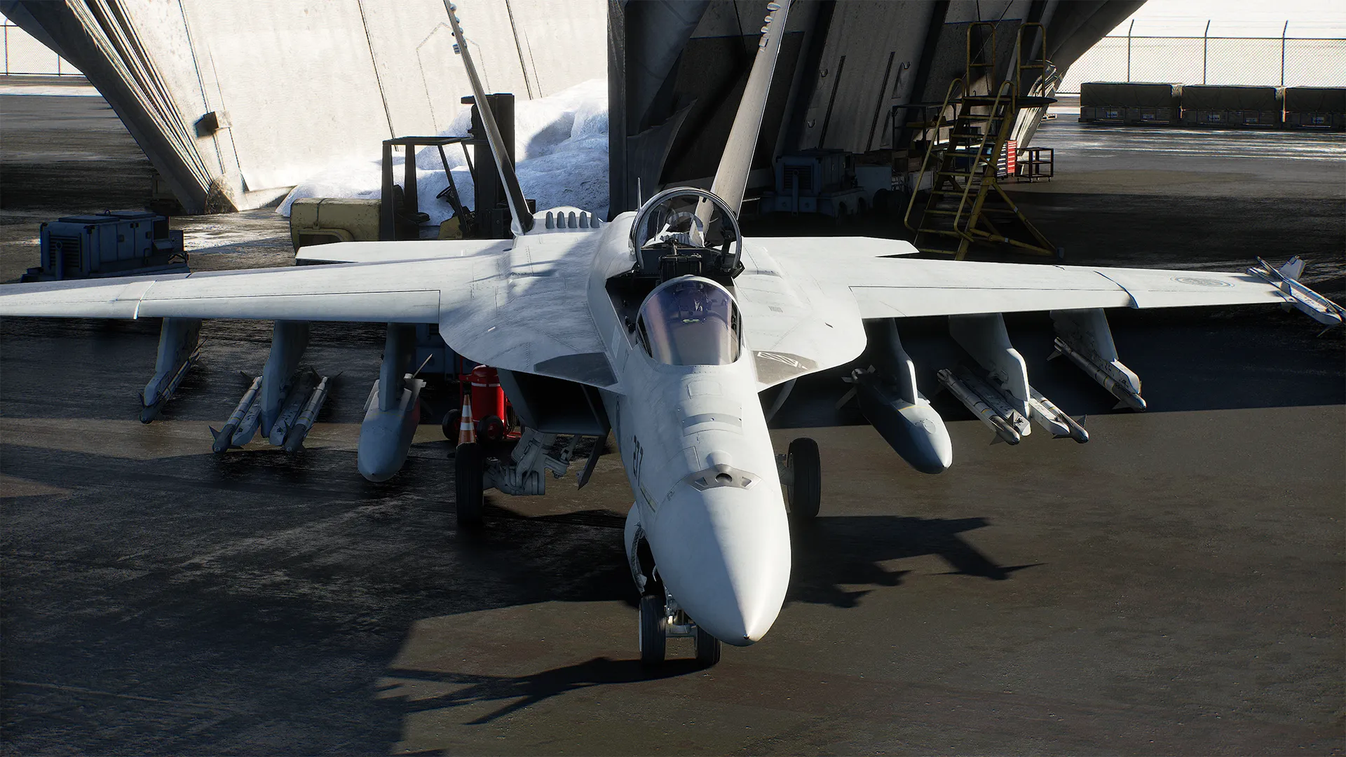 Fighter jet parked head-on inside a hangar