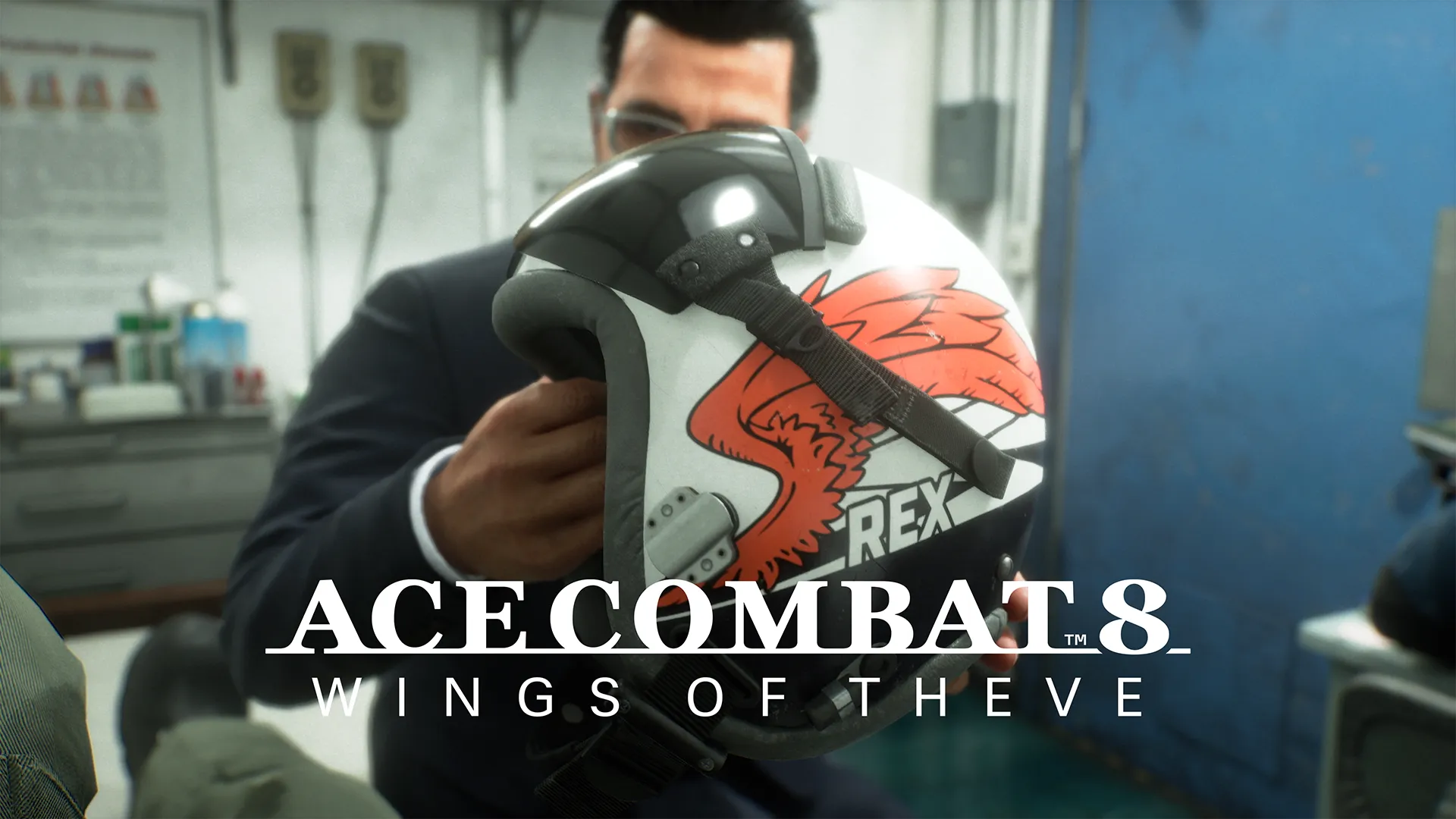 Pilot holding a helmet with a red phoenix emblem